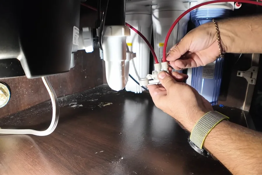 Garbage disposal wiring, drain, and mounting connections under a sink for Garbage Disposal Services in Fountain Valley, CA in Fountain Valley near the service area.