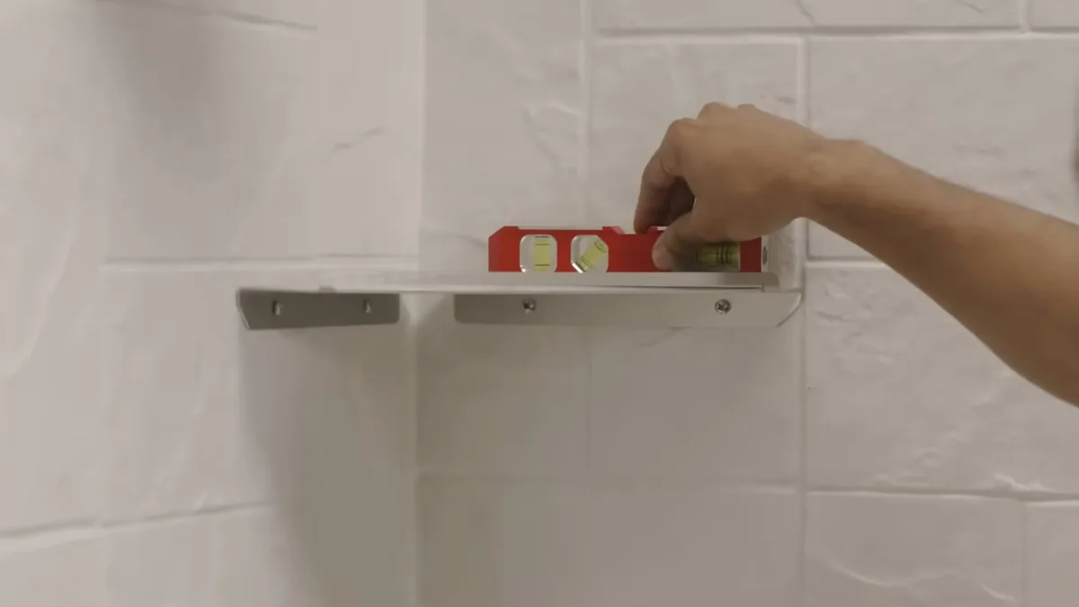 Level being used while installing shower wall hardware for Plumber in Seal Beach, CA in Seal Beach