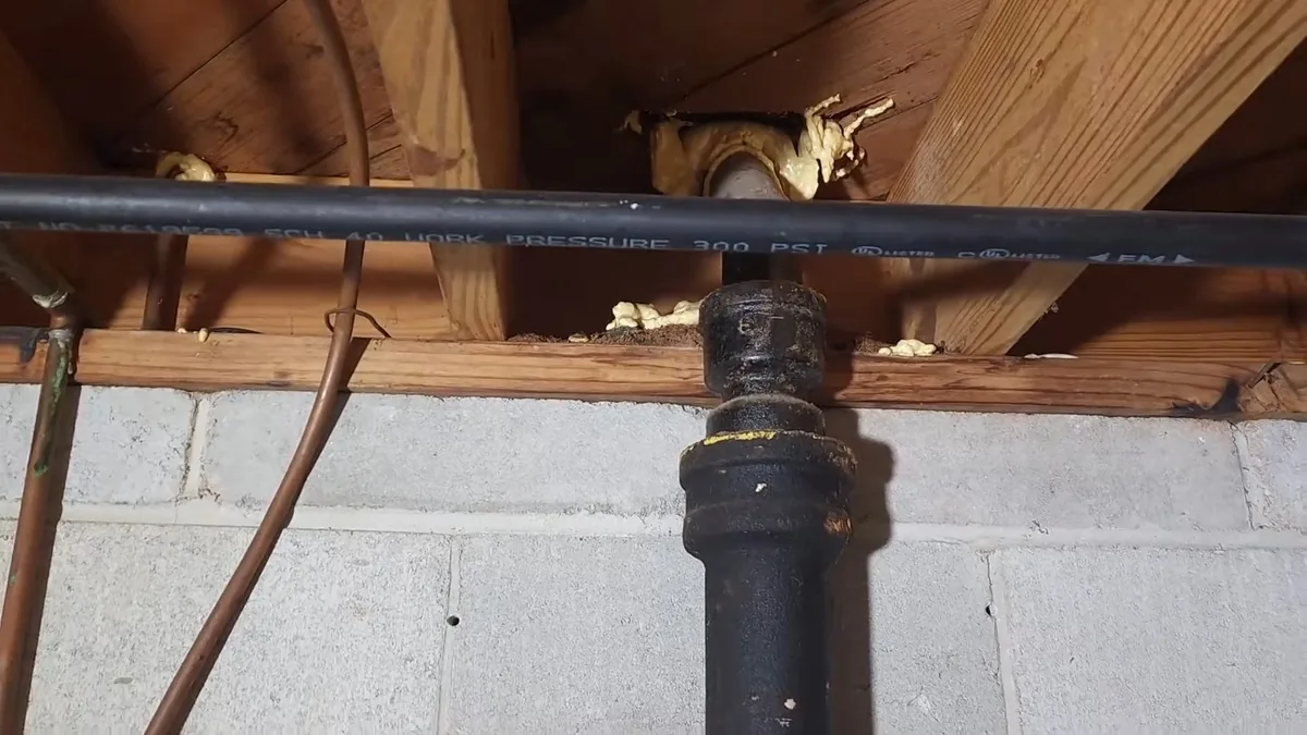 Old cast iron drain pipe being replaced with new piping for Cast Iron Drain Stack Problems in 1960s-70s Homes in Fountain Valley