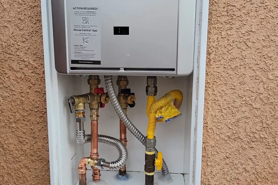 Wall-mounted tankless water heater with gas and water connections for Tankless Water Heater Installation in Fountain Valley, CA in Fountain Valley
